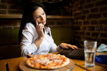 Young businesswoman Communicates with business partners using a laptop and telephone