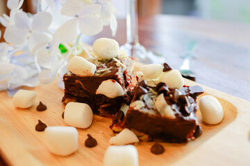 Homemade cookies brownie and marshmallow with cocktails punch served on wooden table.