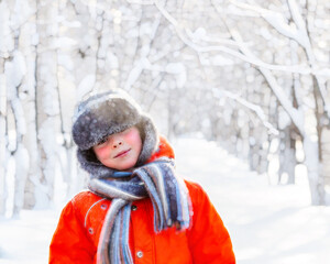 Fototapeta na wymiar Little boy on a frosty day outdoors during winter holidays.