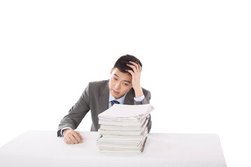 Portrait of young man sitting on desk with stack of files,portrait