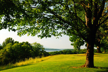 A bucolic view across a river valley to the mountains
