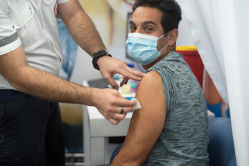 Middle generation people are being vaccinated against coronavirus. Injections are given to save...