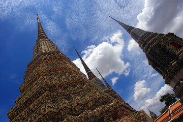 Low angle shot of the Wat Pho Temple in Thailand on a cloudy sky background