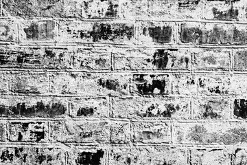 Texture of a brick wall with cracks and scratches which can be used as a background