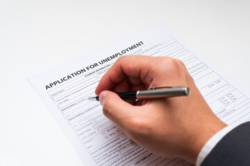 Application for unemployment is being filled by job loser.