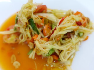 Thai food Somtam or papaya spicy salad on white dish