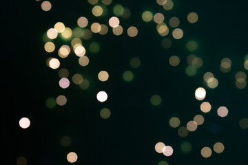 Green and yellow bokeh lights on black background