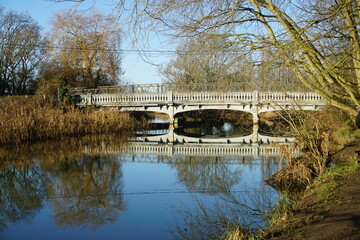 Fototapeta na wymiar White bridge over river Strout, Melford Country Park, Suffolk, Sudbury, January 2021