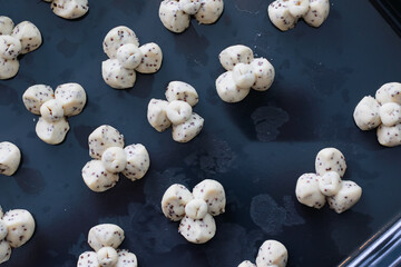 Thai Traditional Dessert Homemade Cookies "Khanom Kleeb Lumduan" look like Flowers. Ready to Baked in Stove.