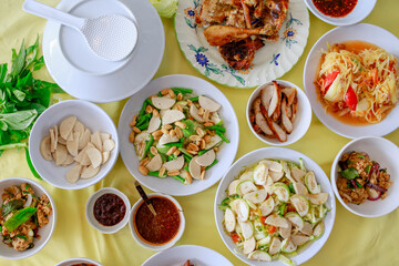 Asian Local and Thai Traditional Food. North-East Style, Sticky rice, Grilled Chicken, Papaya Salad and Grilled Pork with Thai Spicy Sauce.