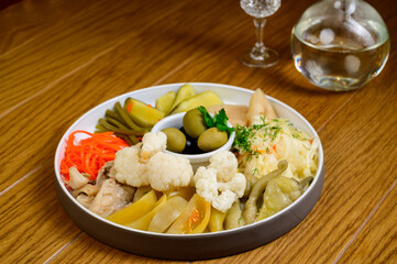 Different types of pickled vegetables on a white plate