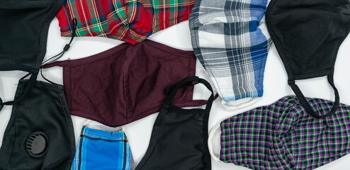 Handmade face protective masks on blue flat lay background. Reusable fabric face masks against coronavirus, covid-19 or flu. Pattern of medical mask