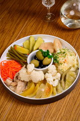 Different types of pickled vegetables on a white plate