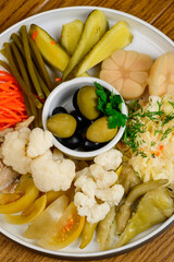 Different types of pickled vegetables on a white plate
