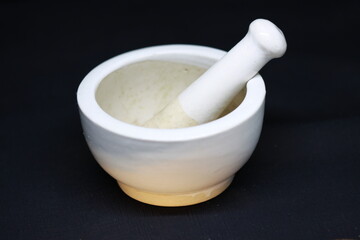 Empty ceramic  mill pot with grinding stone