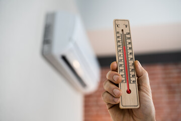 Home Air Condition On Wall And Thermometer