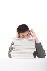 Portrait of young man sitting on desk with stack of files,portrait