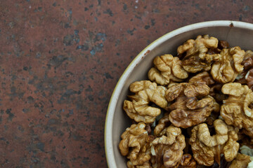 Walnuts harvest on vintage metal background. Walnut kernels. Countryside agriculture. Organic autumn nuts harvest.