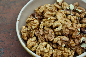 Walnuts harvest on vintage metal background. Walnut kernels. Countryside agriculture. Organic autumn nuts harvest.