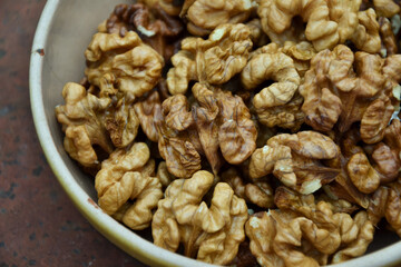 Walnuts harvest on vintage metal background. Walnut kernels. Countryside agriculture. Organic autumn nuts harvest.