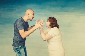 A tall bald man and plump red-haired attractive woman on a blue background, the husband scolds his...