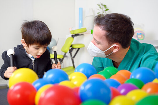 Physical therapist playing with children, with cerebral palsy. High quality photo