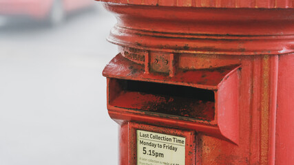 Old red post box on a foggy morning
