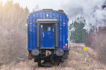 Obraz premium Steam train moves at autumn day time.