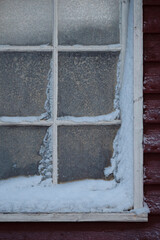 old window on a wall with frost patterns