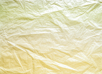 Fototapeta premium Worn, old, crumpled paper. The background for the texture looks like crumpled parchment in yellow and green tones