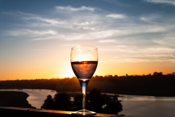 sunset behind a glass of wine overlooking Newport bay in California