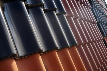 Roof covered with tiles in different colors. Roofing.