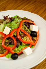 Salad with lettuce, pepper and parmesan cheese