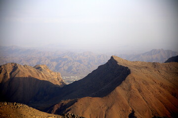 View of the mountains with a glimpse of the city below, Jabal Akhdar, towards Nizwa, Oman