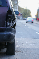 Damaged car in car crash traffic accident on city road.