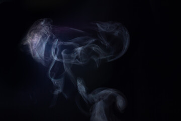 Steam from hot water on a black background