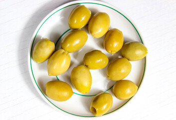 Pitted olives in a saucer close up.