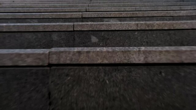 tracking camera movement of going up the stairs in the city long shot view with low angle