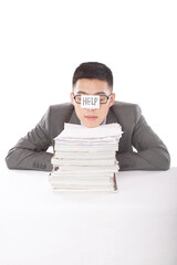 Portrait of young bisinessman leaning on stack of files 