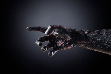 Fototapeta na wymiar Creepy zombie hand over dark background with clipping path