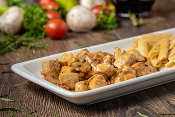 grilled cubed chicken with past and salad