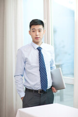 Portrait of young bisiness man using laptop 