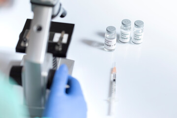 Covid-19 vaccine dose under a microscope.