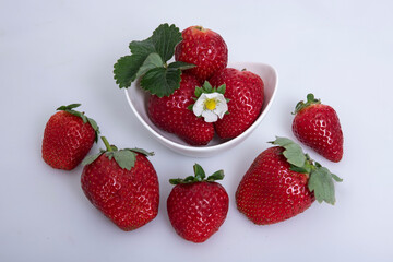 Fresh strawberry in plate on white background.
