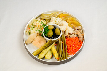 Different types of pickled vegetables on white background