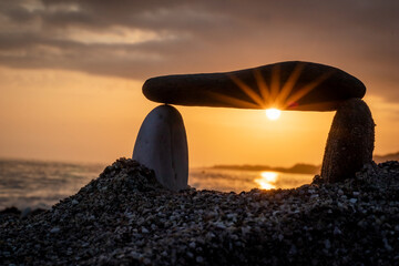 stone dolmen for meditation on the beach at sunset