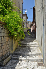 A narrow street between the stone houses of Morcone, an old town in the province of Benevento,...