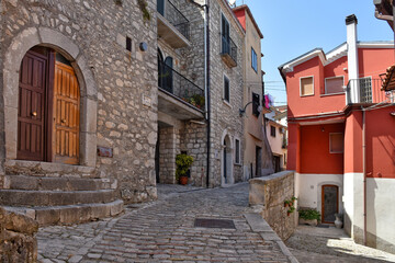 A narrow street between the stone houses of Morcone, an old town in the province of Benevento, Italy.
