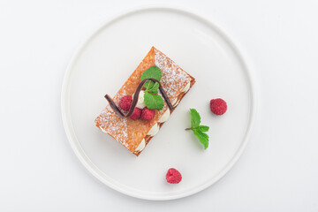 raspberry mille feuille dessert on a white plate, top view