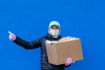 girl volunteer with charity box, on blue background